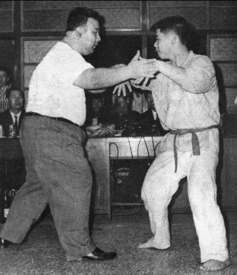 Hong Yixiang demonstrating with a student